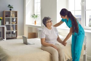 An older adult sitting with a notepad, reviewing care options with a supportive family member indoors.