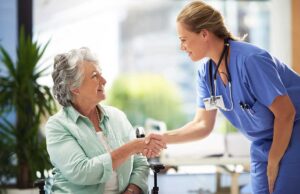 Resident reviews a care chart with a staff member at a bright assisted living table.