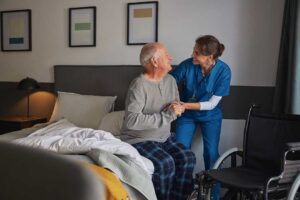 Family members sit with an older adult during a welcoming assisted living group activity.